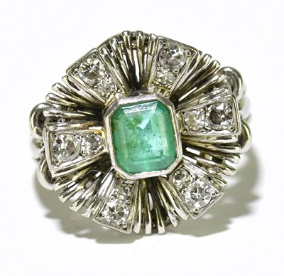 Lot 22 - A white metal emerald and diamond ring, the...