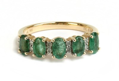 Lot 53 - A 14ct yellow gold emerald and diamond ring,...