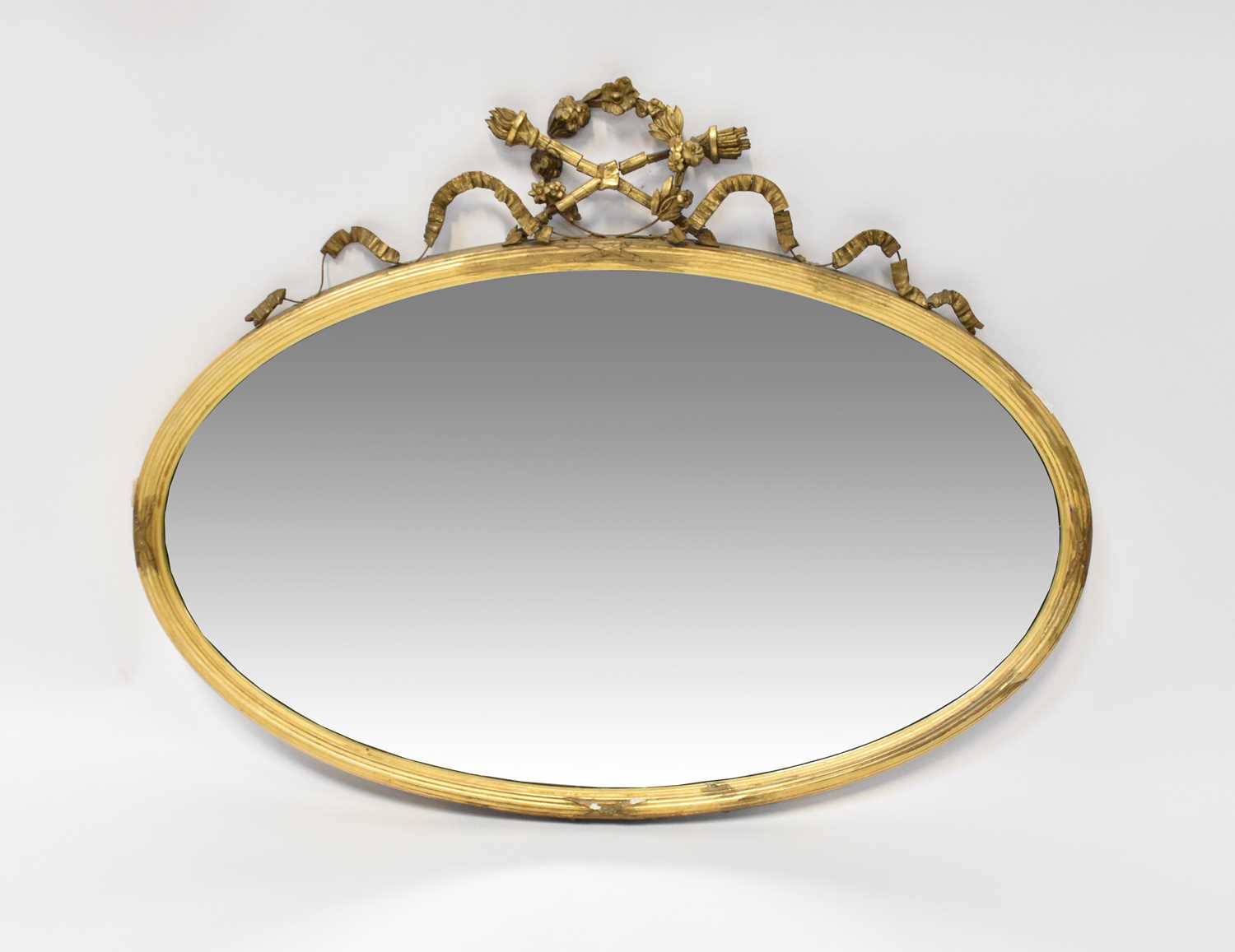 Lot 117 - An oval gilt framed wall mirror, with laurel...