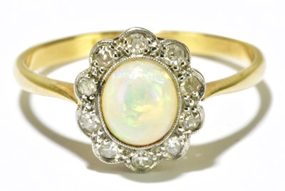 Lot 89 - An 18ct yellow gold opal and diamond chip...