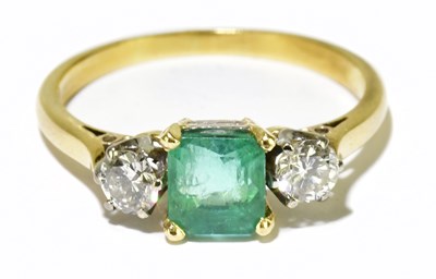 Lot 85 - A yellow metal emerald and diamond three stone...