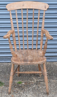 Lot 48 - An elm seated kitchen Windsor elbow chair on...