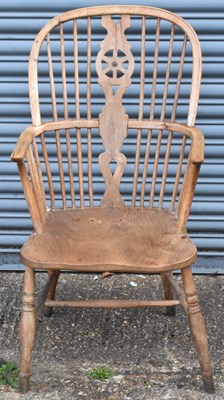 Lot 49 - An elm seated Windsor wheel back elbow chair...