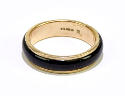 Lot 110 - A 9ct yellow gold band with applied dark...