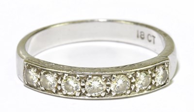 Lot 73 - An 18ct white gold and seven stone diamond...