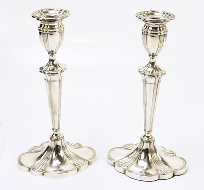 Lot 242 - A pair of silver plated candlesticks of oval...