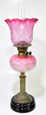 Lot 2325 - A Victorian oil lamp, the cranberry and clear...