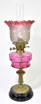 Lot 2327 - A Victorian oil lamp, the cranberry and clear...
