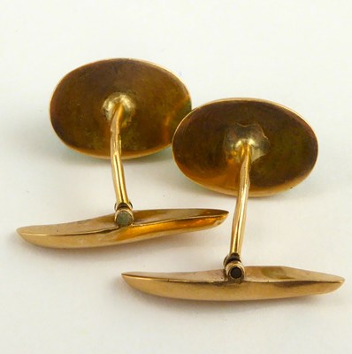 Lot 1097 - A pair of 9ct gold cufflinks set with green...