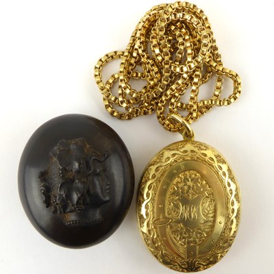 Lot 1085 - A Victorian oval yellow metal double locket...