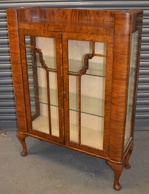 Lot 37 - An Art Deco style walnut two door display...