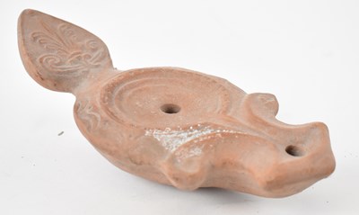 Lot 245 - A Roman style terracotta oil lamp, length 20cm.