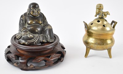 Lot 555 - A small Chinese brass seated Buddha, height...