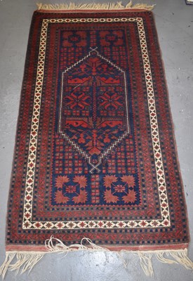 Lot 98 - A hand knotted woollen rug with geometric...