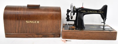 Lot 246 - An oak cased Singer sewing machine.