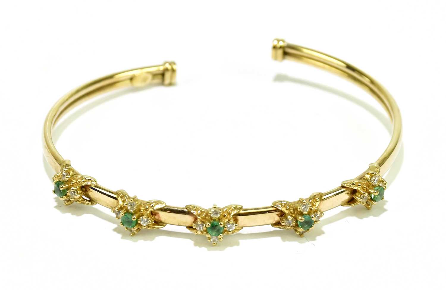 Lot 533 - A 9ct yellow gold open bangle set with...