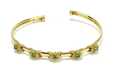 Lot 533 - A 9ct yellow gold open bangle set with...