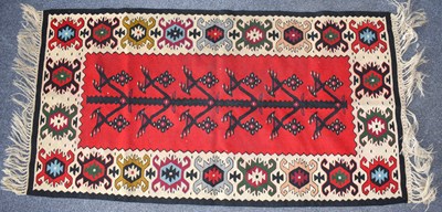 Lot 123 - A Middle Eastern short runner with red central...