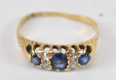 Lot 744 - An 18ct yellow gold diamond and sapphire ring,...