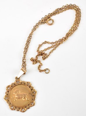 Lot 751 - A 9ct gold pendant on yellow metal chain,...