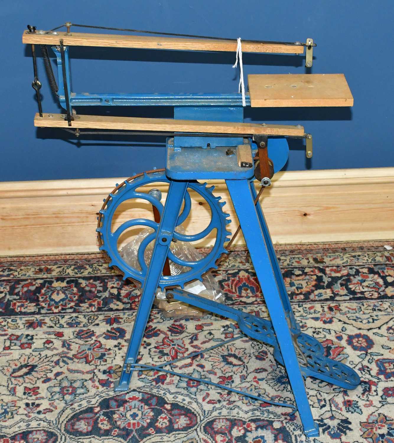 Lot 2318 - A blue painted fret machine, height 82cm.