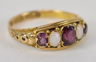 Lot 743 - A 15ct yellow gold ruby and opal set ring,...