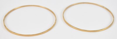 Lot 712 - A pair of 9ct yellow gold bangles, diameter...