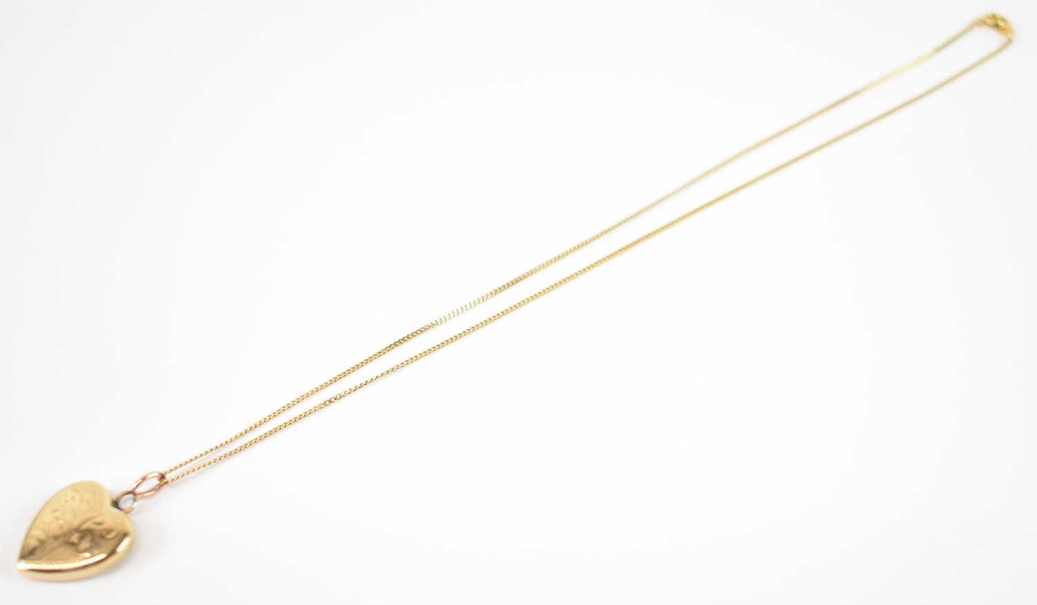 Lot 775 - A 9ct yellow gold locket pendant suspended on...