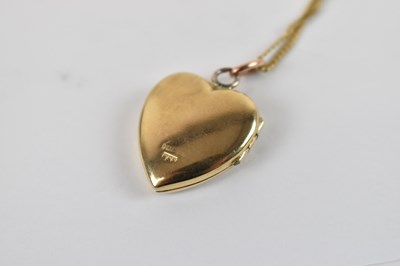 Lot 775 - A 9ct yellow gold locket pendant suspended on...