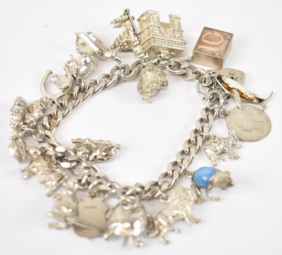 Lot 794 - A hallmarked silver charm bracelet with silver...