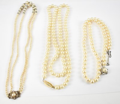 Lot 797 - A group of three pearl necklaces, one with...