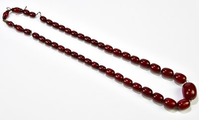 Lot 389 - A vintage cherry amber graduated bead necklace,...