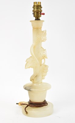 Lot 86 - An alabaster table lamp decorated with...