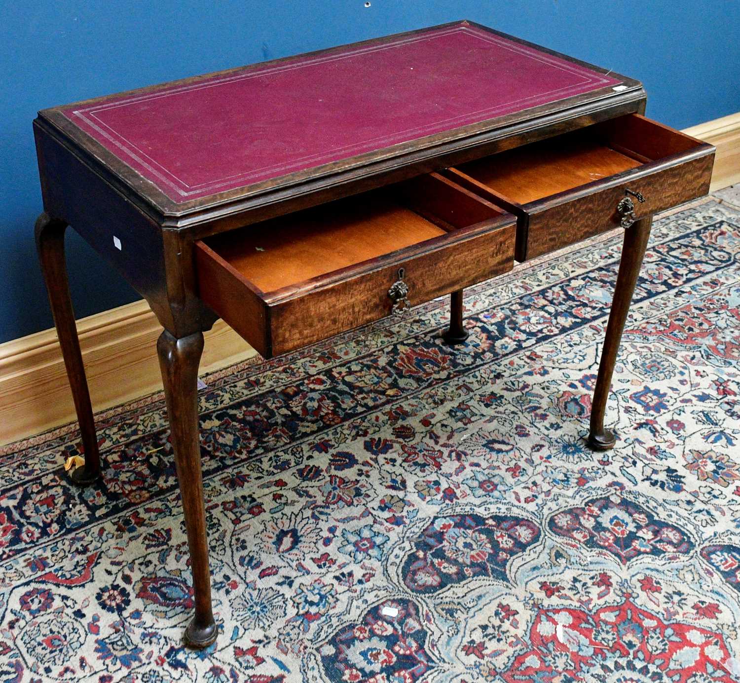 Lot 2598 - A 1950s writing table with leather inset top...