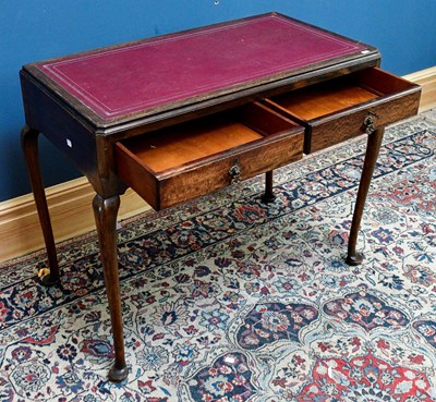 Lot 2598 - A 1950s writing table with leather inset top...