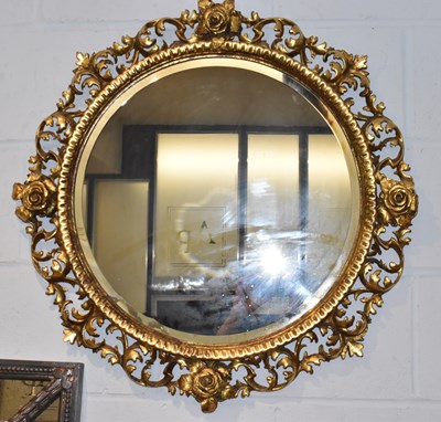 Lot 11 - A gilt framed circular bevelled wall mirror,...