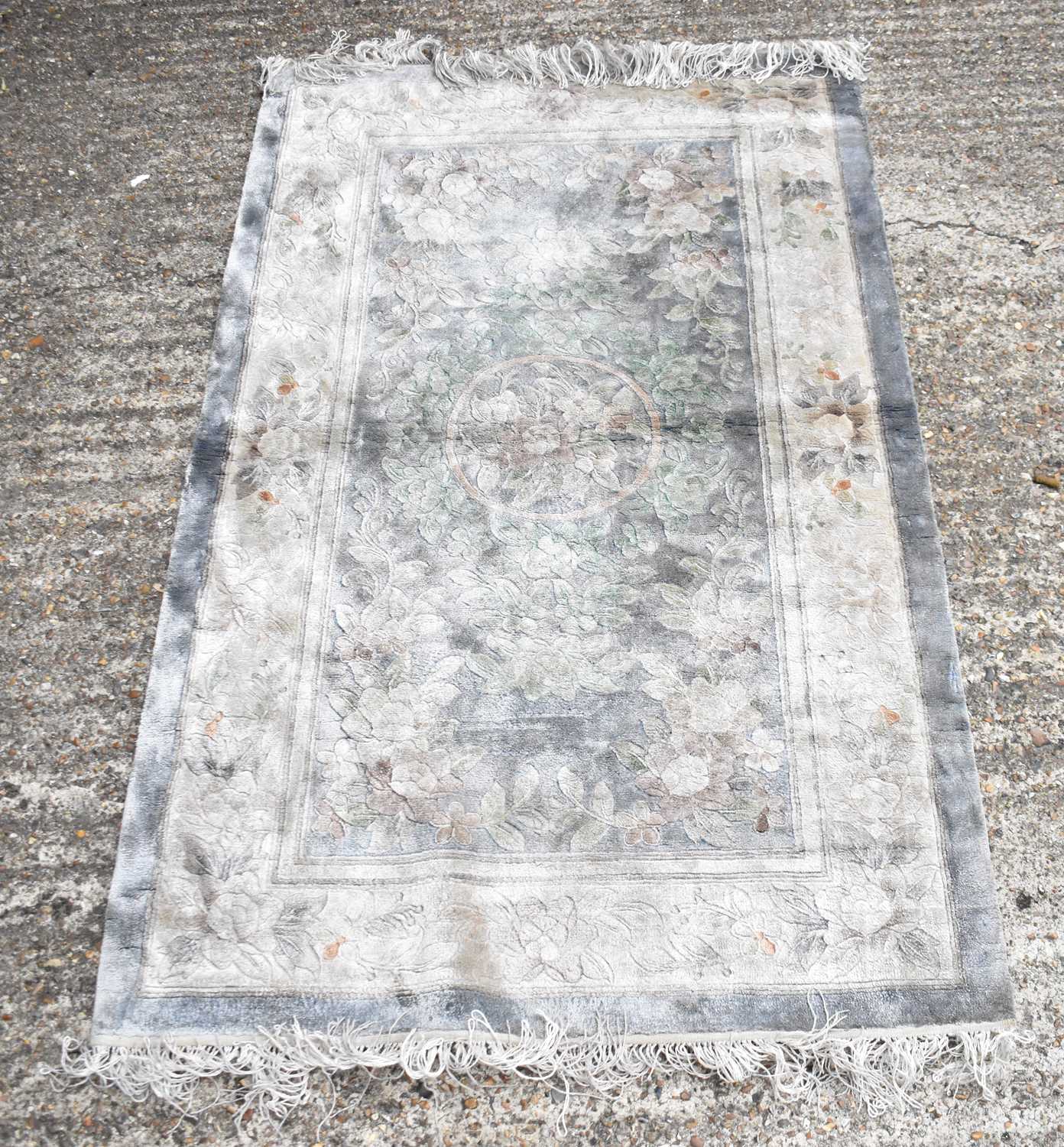 Lot 104 - A Chinese style floral decorated rug with