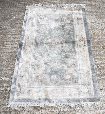 Lot 104 - A Chinese style floral decorated rug with...