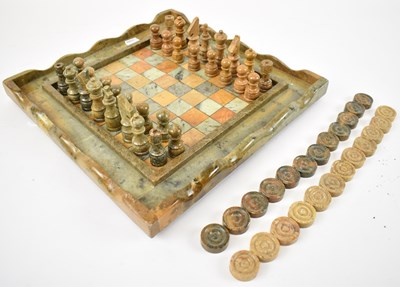 Lot 259 - A hardstone chess board with pieces, 34 x 34cm.