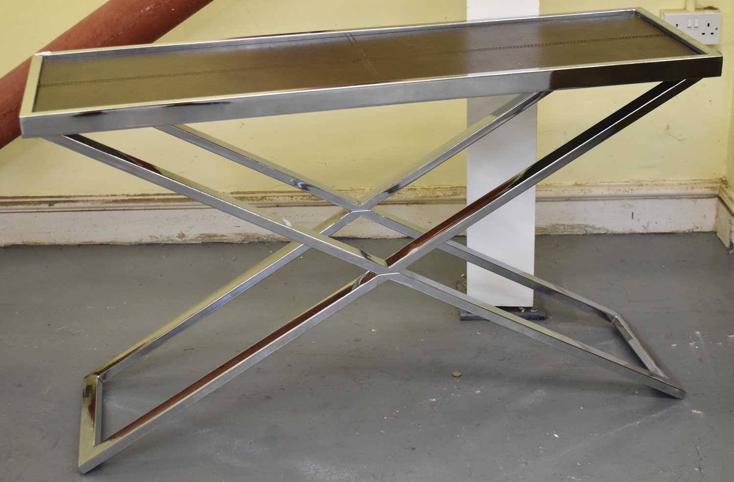 Lot 42 - A modern chrome X-frame consol table with...