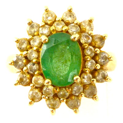 Lot 979 - A 14k emerald and diamond cluster ring, the...