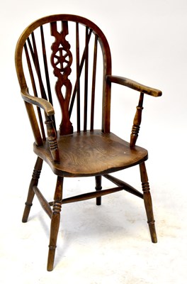 Lot 19 - A 19th century provincial, probably elm Windsor chair