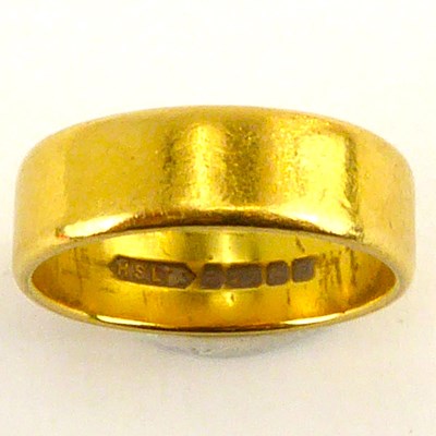 Lot 980 - A 22ct gold wedding band, size L/M, approx. 5.4g.