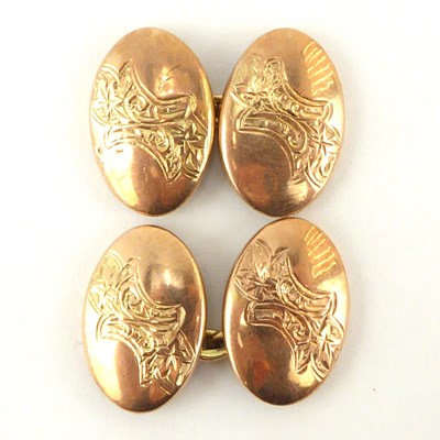 Lot 1098 - A pair of 9ct gold oval cufflinks with floral...