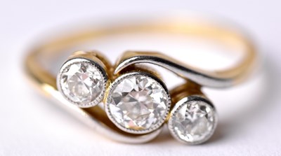 Lot 104 - A yellow metal diamond set three stone ring,...