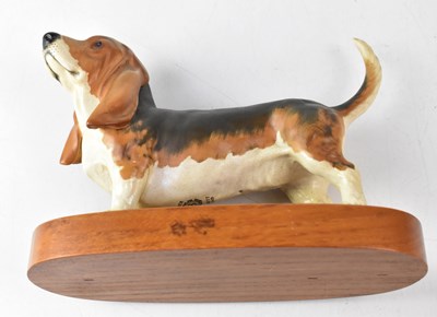 Lot 451 - BESWICK; a figure of a Basset hound on wooden...