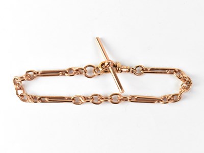 Lot 1157 - A 9ct rose gold Albert chain with T bar,...