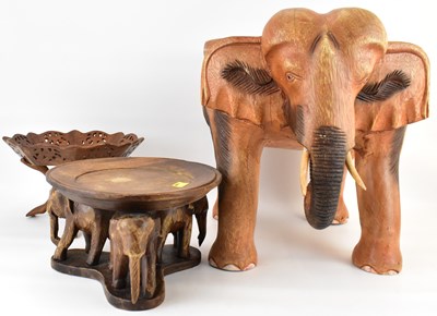 Lot 205 - A carved wooden stool in the form of an...