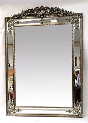 Lot 115 - A large modern bevel edged mirror within an...