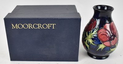 Lot 471 - MOORCROFT; a small blue ground vase decorated...